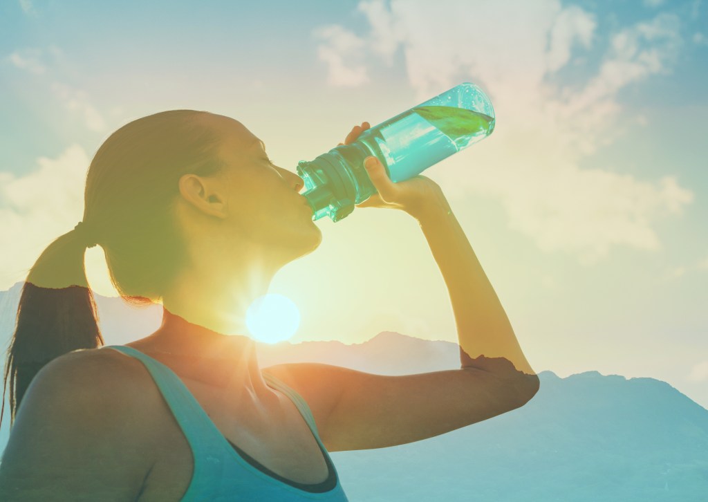Fit women drinking water