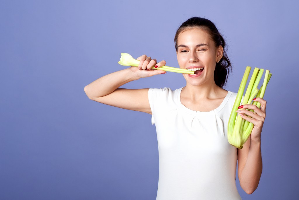 Woman eating celery