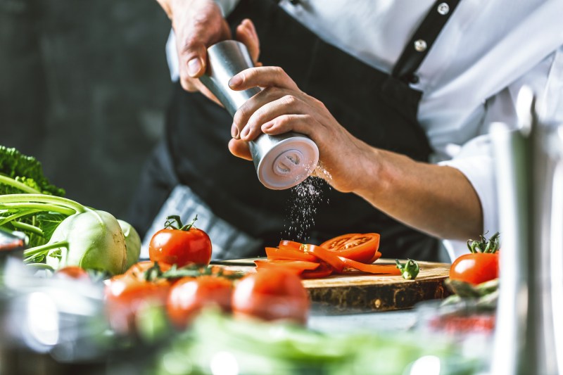 Chef Grinding salt over vegetables
