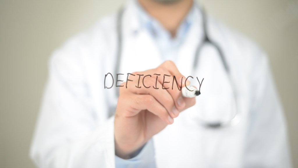 doctor writing the word deficiency