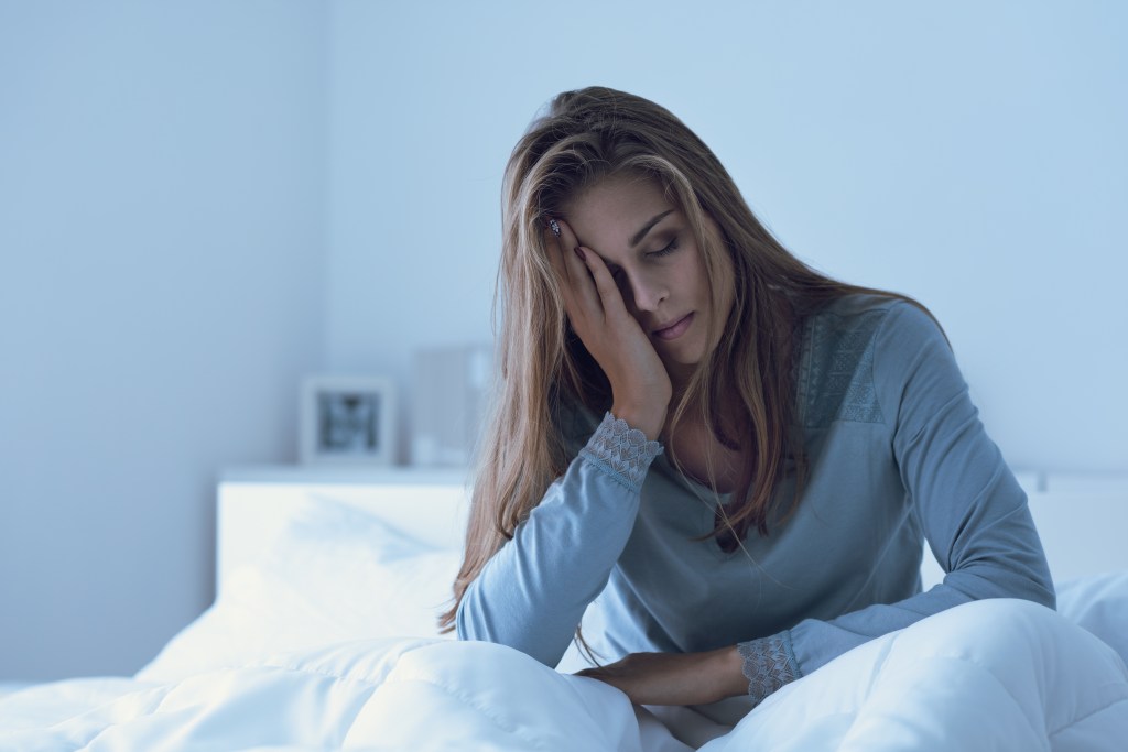 Depressed woman sitting in bed