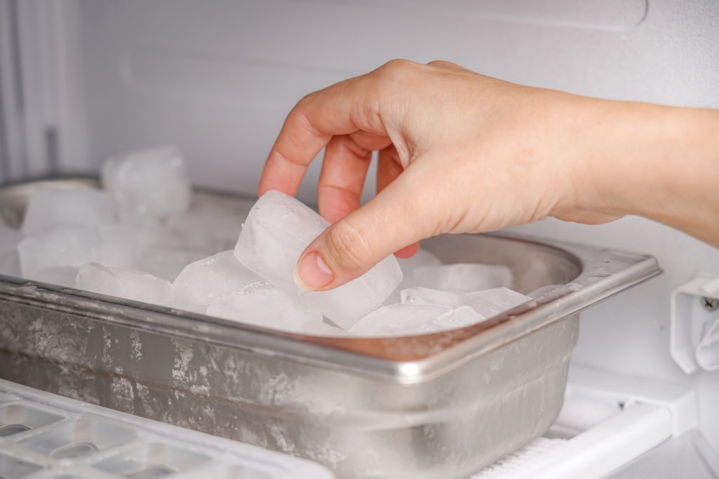 Woman getting ice from the freezer