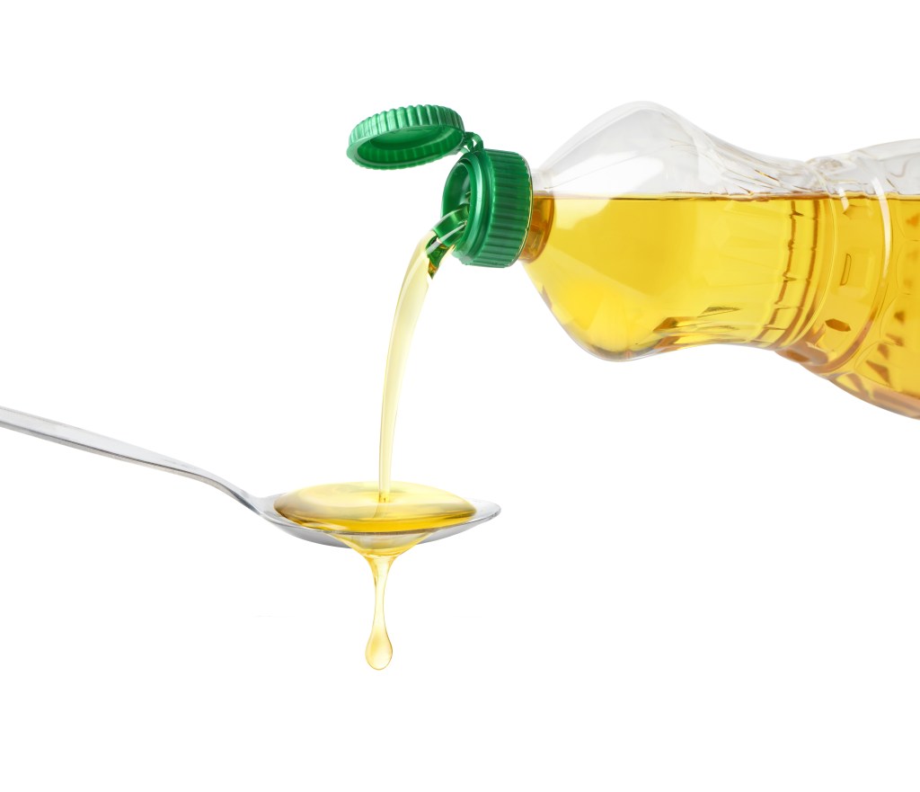 Pouring cooking oil into a spoon