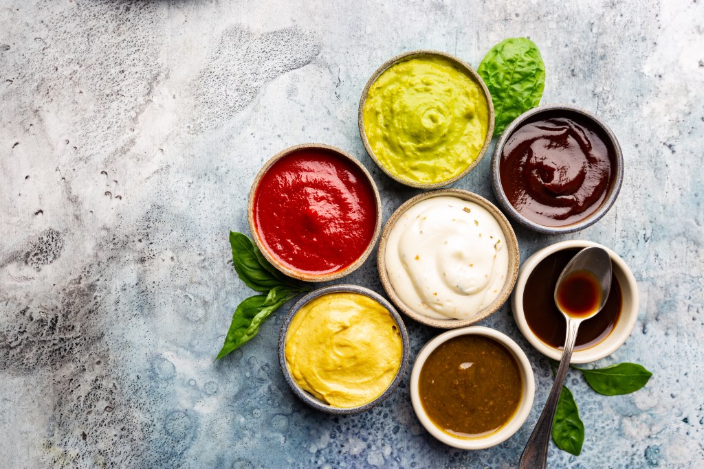 a group of bowls of different sauces