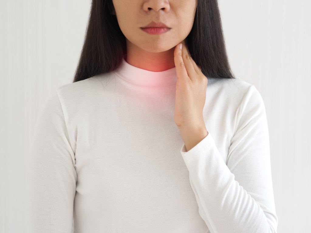 Woman with throat pain