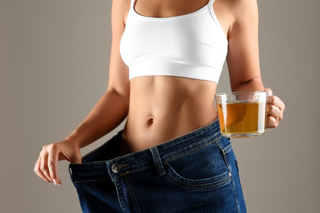 woman losing weight with a cup of tea