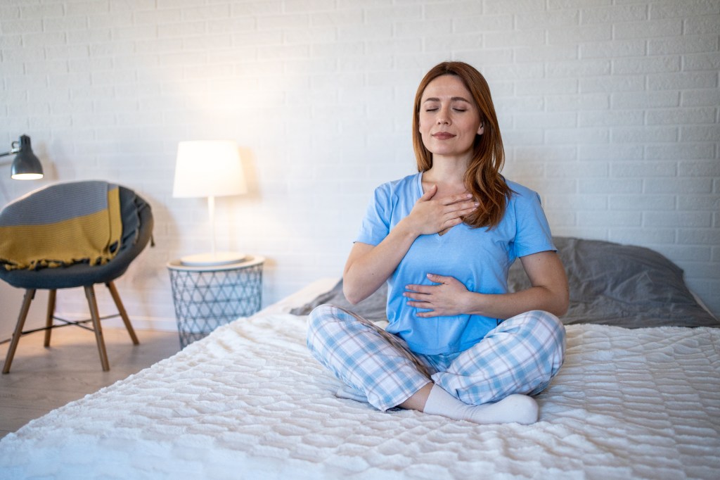 Woman sitting on a bed