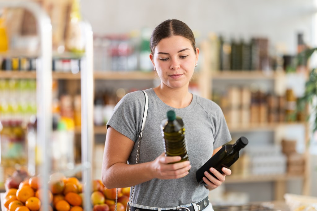 Girl buying olive oil